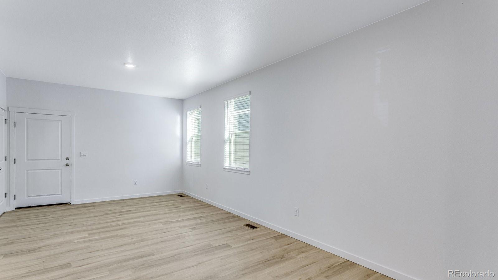 1358 South Chester Street, Unit B Denver, CO 80247 - Photo 12 of 42 a view of empty room with wooden floor and fan