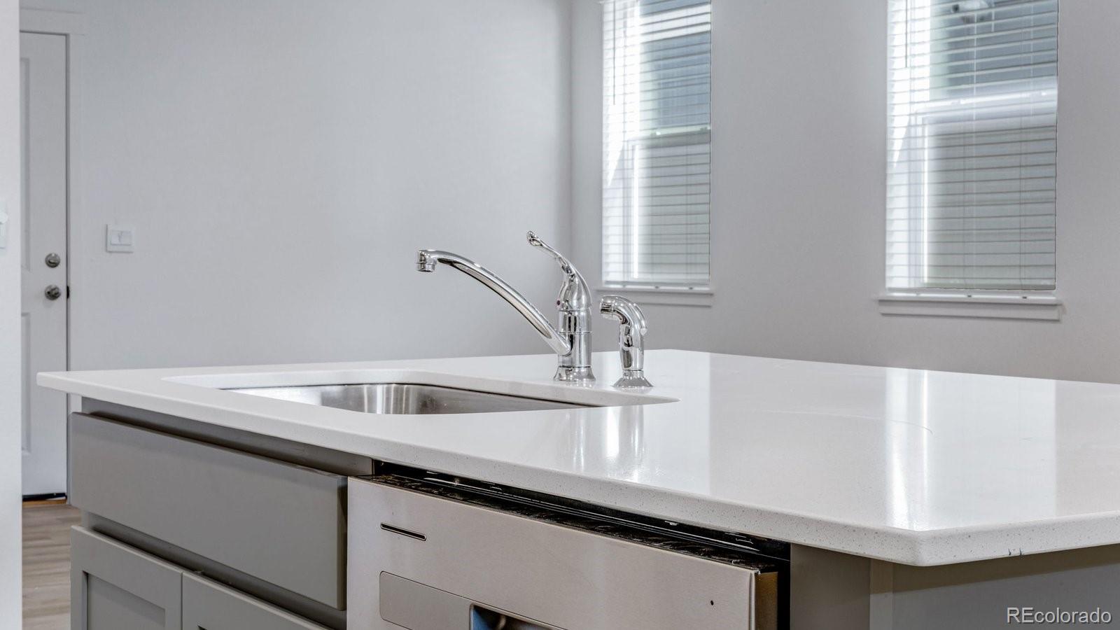 1358 South Chester Street, Unit B Denver, CO 80247 - Photo 24 of 42 a kitchen with a sink and a window