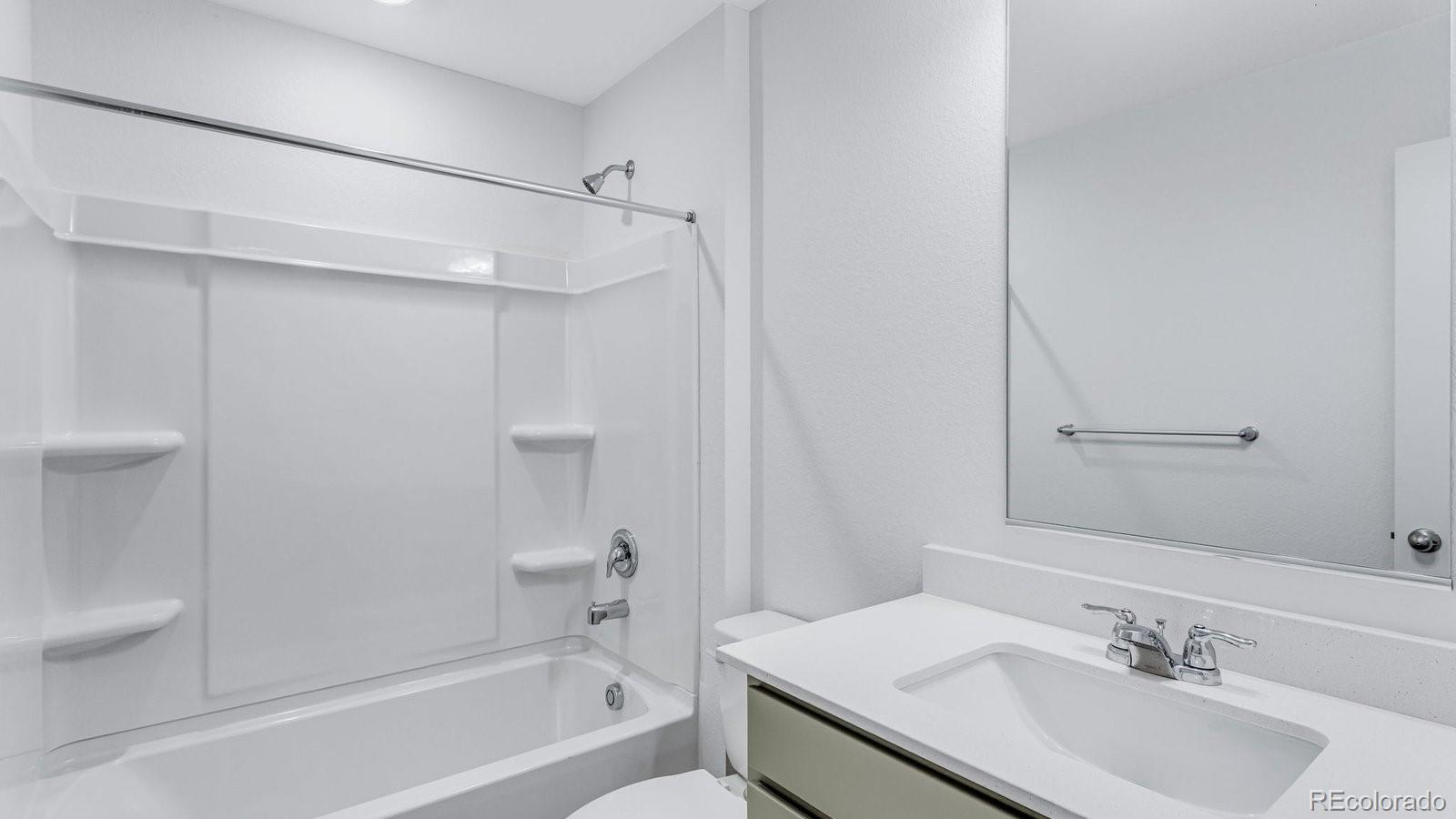 1358 South Chester Street, Unit B Denver, CO 80247 - Photo 33 of 42 a bathroom with a sink toilet and shower