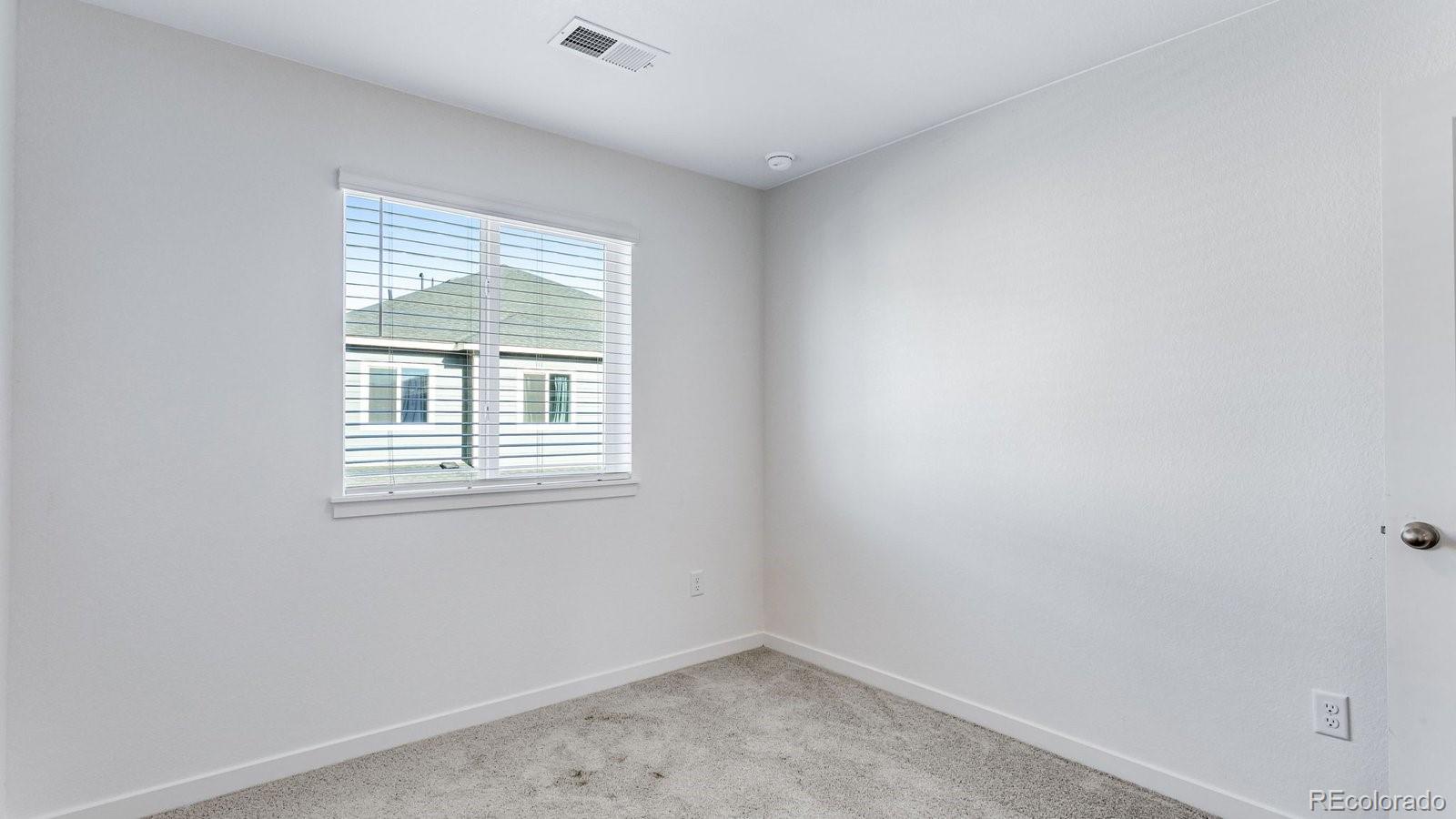 1358 South Chester Street, Unit B Denver, CO 80247 - Photo 35 of 42 an empty room with a window