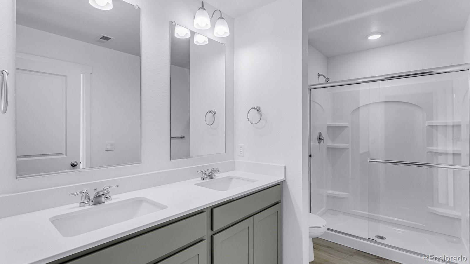 1358 South Chester Street, Unit B Denver, CO 80247 - Photo 42 of 42 a bathroom with a sink shower and a mirror