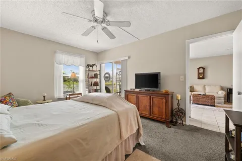 a bedroom with a large bed and a flat screen tv