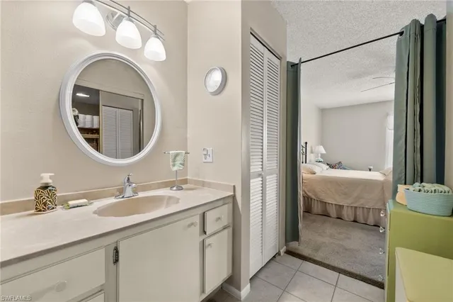 a en suite bathroom with a double vanity sink and a mirror