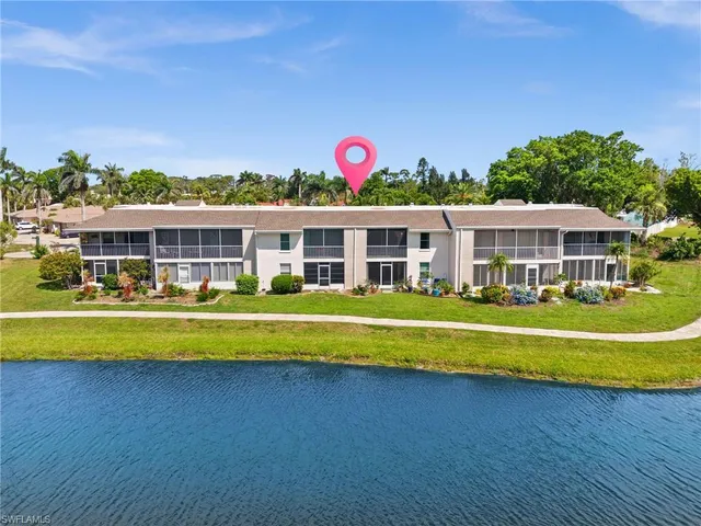 a view of a city with tall buildings and a big yard with table and chairs