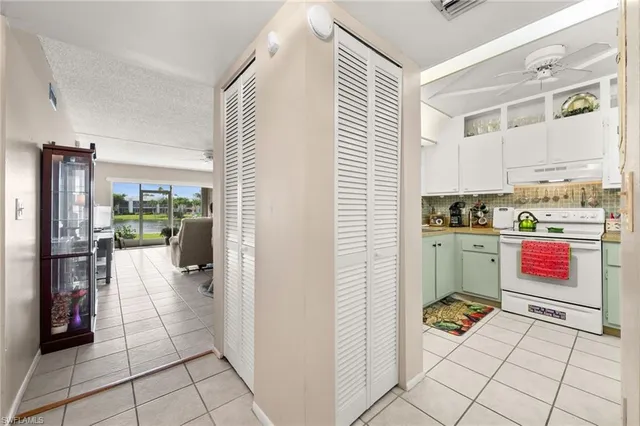 a kitchen with a refrigerator and a stove top oven