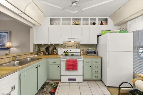a kitchen with stainless steel appliances a refrigerator sink and cabinets