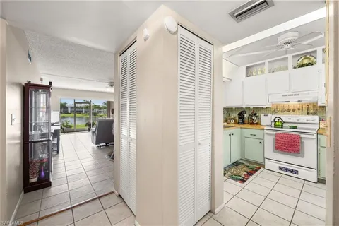 a kitchen with a refrigerator and a stove top oven