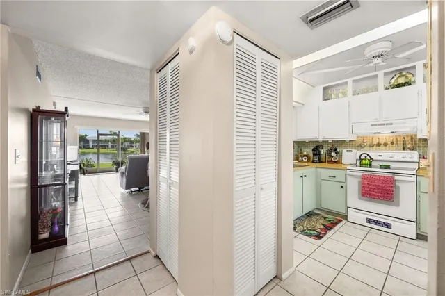 a kitchen with a refrigerator and a stove top oven