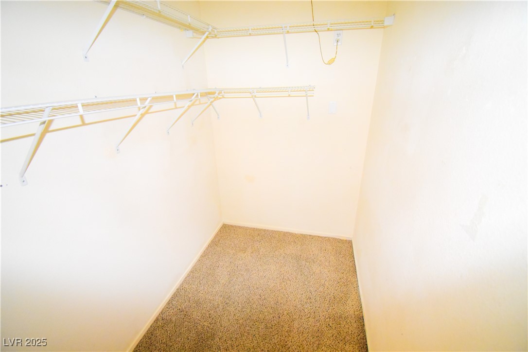 1901 Villa Palms Court, Unit 101 Las Vegas, NV 89128 - Photo 12 of 19 Walk in closet featuring carpet