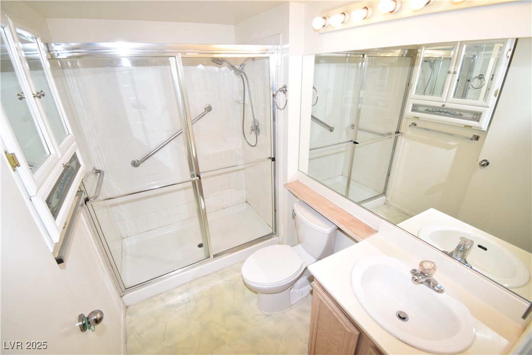 1901 Villa Palms Court, Unit 101 Las Vegas, NV 89128 - Photo 9 of 19 Full bathroom with vanity and an enclosed shower