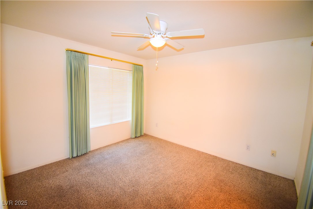 1901 Villa Palms Court, Unit 101 Las Vegas, NV 89128 - Photo 10 of 19 Carpeted empty room featuring ceiling fan