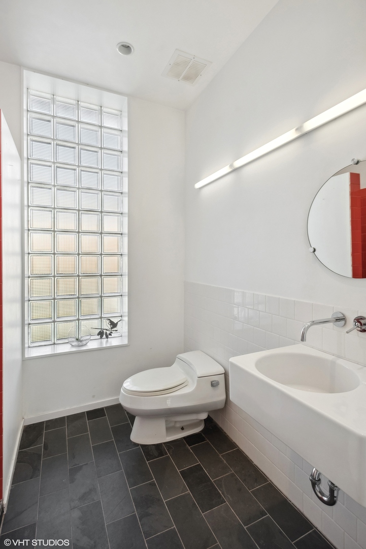 3238 South Green Street Chicago, IL 60608 - Photo 8 of 15 a bathroom with a sink toilet and shower