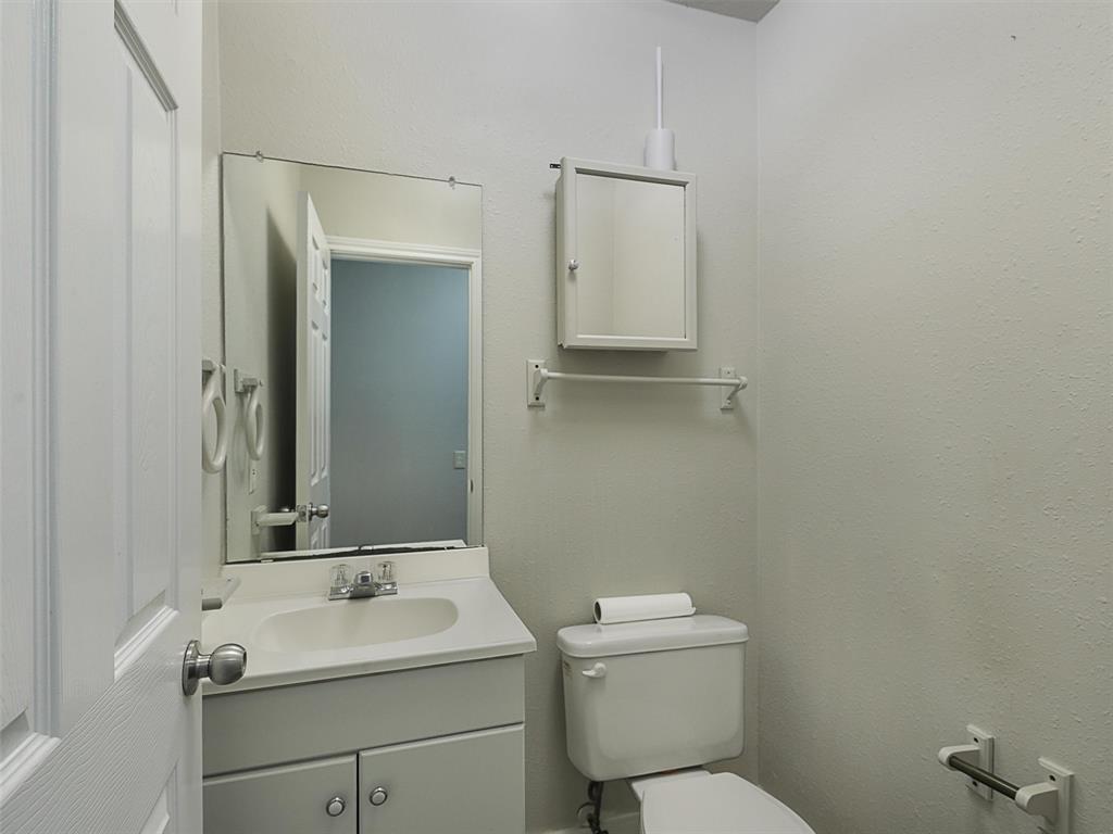 707 Doris Lane Gunter, TX 75058 - Photo 14 of 25 a bathroom with a toilet sink and mirror