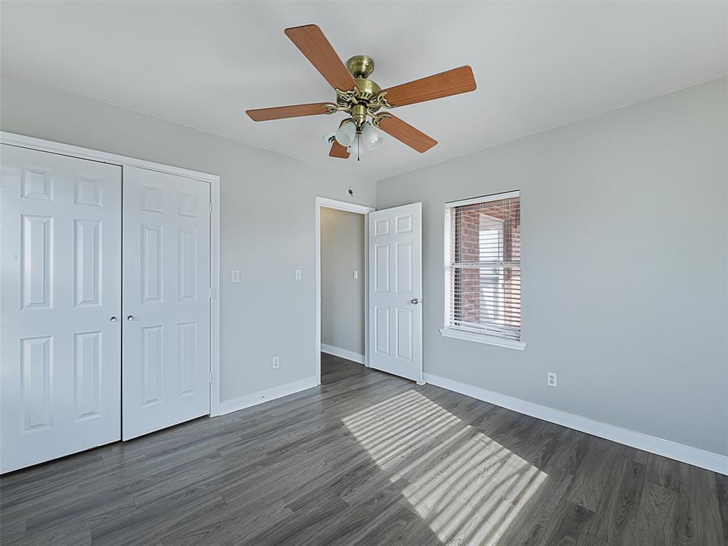 707 Doris Lane Gunter, TX 75058 - Photo 17 of 25 a view of an empty room with wooden floor and a window