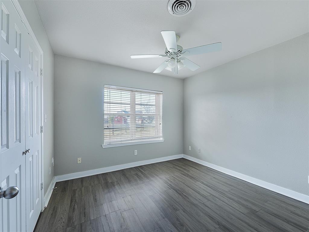 707 Doris Lane Gunter, TX 75058 - Photo 20 of 25 a view of an empty room with wooden floor and a window