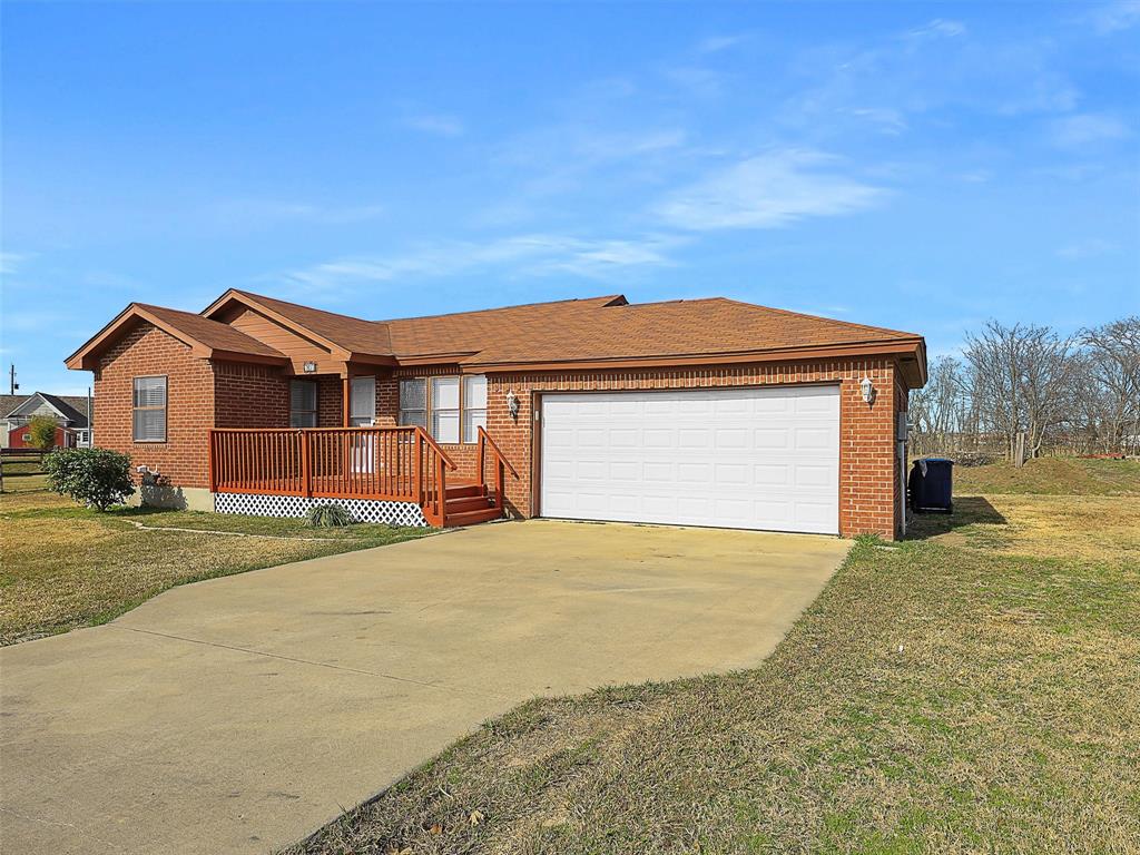 707 Doris Lane Gunter, TX 75058 - Photo 2 of 25 a front view of a house with a yard and garage
