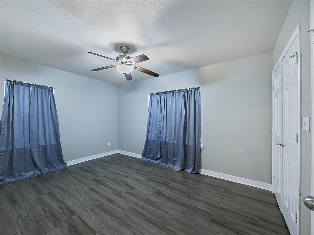 707 Doris Lane Gunter, TX 75058 - Photo 21 of 25 an empty room with wooden floor and windows