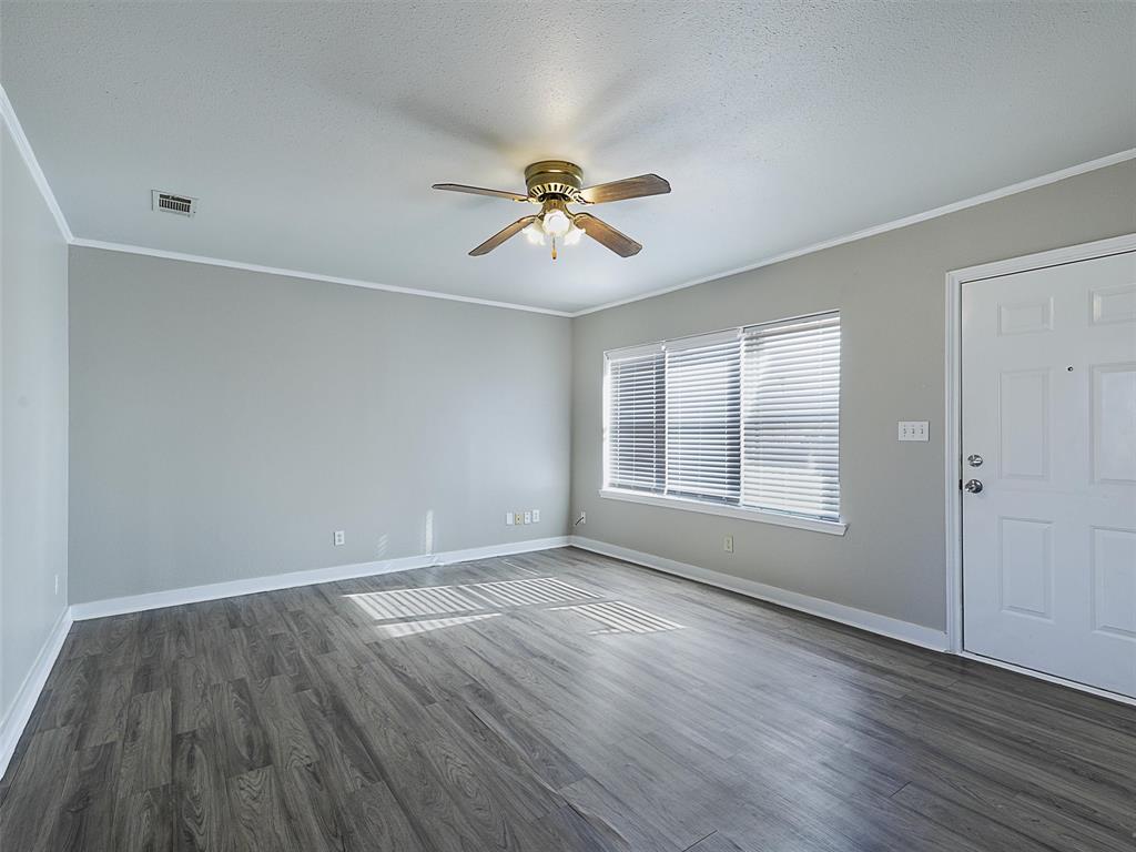 707 Doris Lane Gunter, TX 75058 - Photo 4 of 25 an empty room with wooden floor and windows