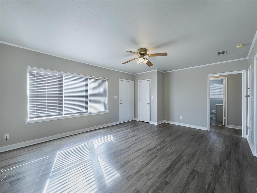 707 Doris Lane Gunter, TX 75058 - Photo 5 of 25 a view of an empty room with a window and wooden floor