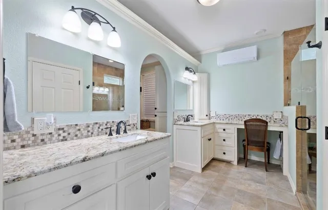 a spacious bathroom with a granite countertop sink mirror and bathtub