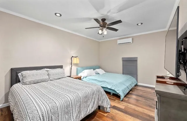 a bedroom with two beds and a ceiling fan