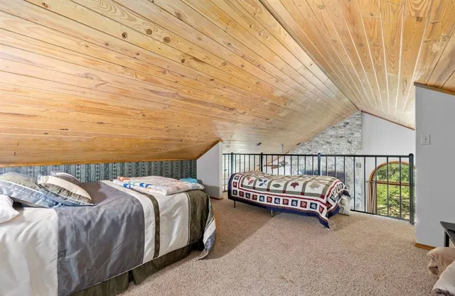 a bed sitting in a bedroom next to a window