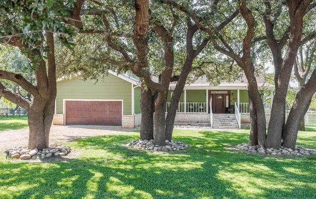 a front view of house with yard and green space