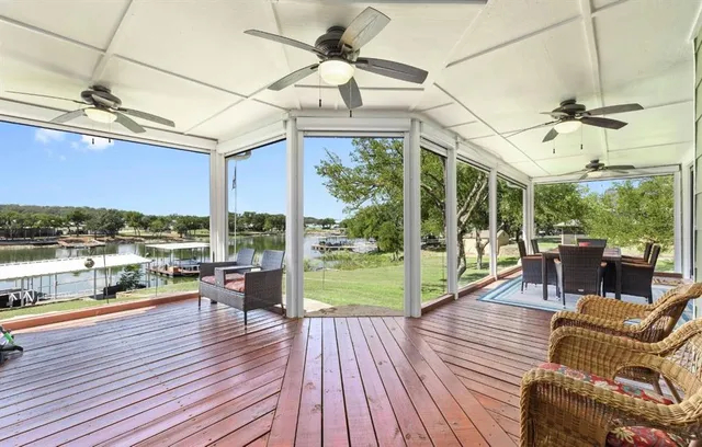 a living room with patio furniture and a floor to ceiling window