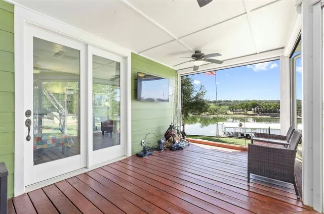a view of a patio with wooden floor and iron stairs