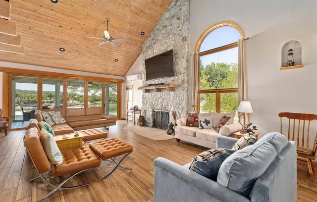 a living room with furniture a large window and a flat screen tv