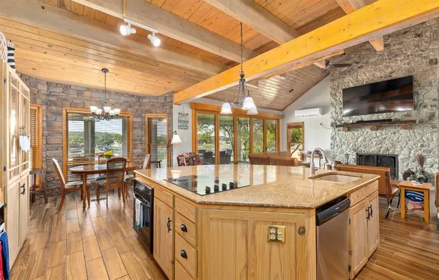 a kitchen with granite countertop a sink and wooden floor