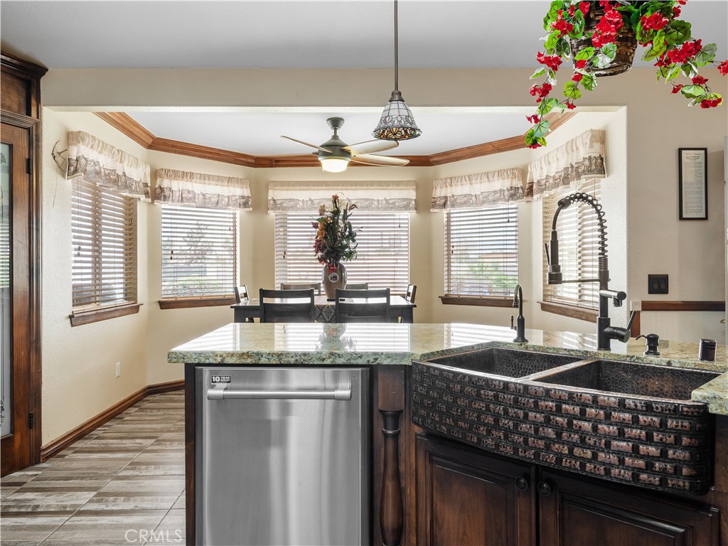 13991 Jicarilla Road Apple Valley, CA 92307 - Photo 13 of 44 a kitchen with granite countertop a sink stainless steel appliances and a counter top space