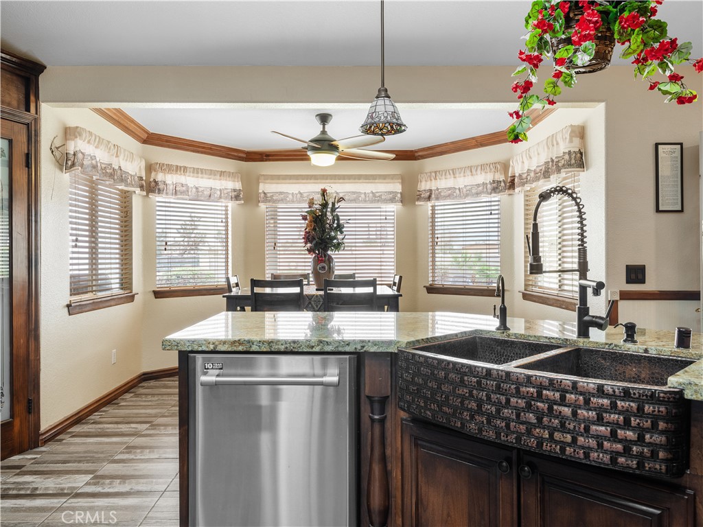 13991 Jicarilla Road Apple Valley, CA 92307 - Photo 15 of 44 a kitchen with granite countertop a sink stainless steel appliances and a counter top space