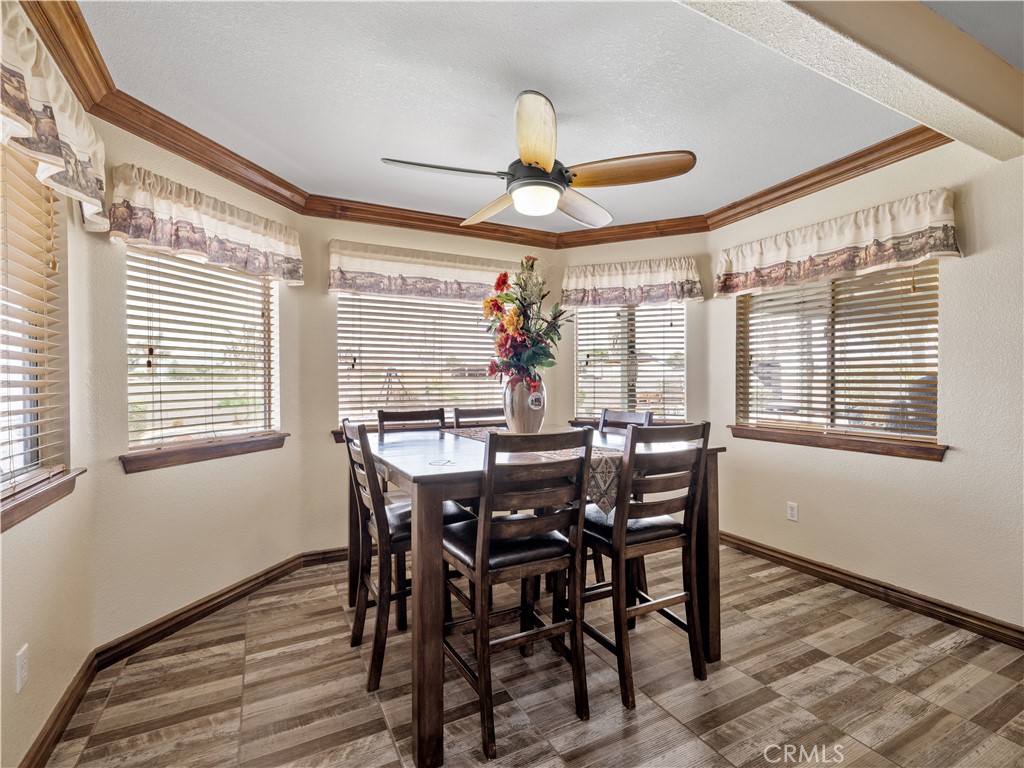 13991 Jicarilla Road Apple Valley, CA 92307 - Photo 16 of 44 a view of a dining room with furniture window and wooden floor