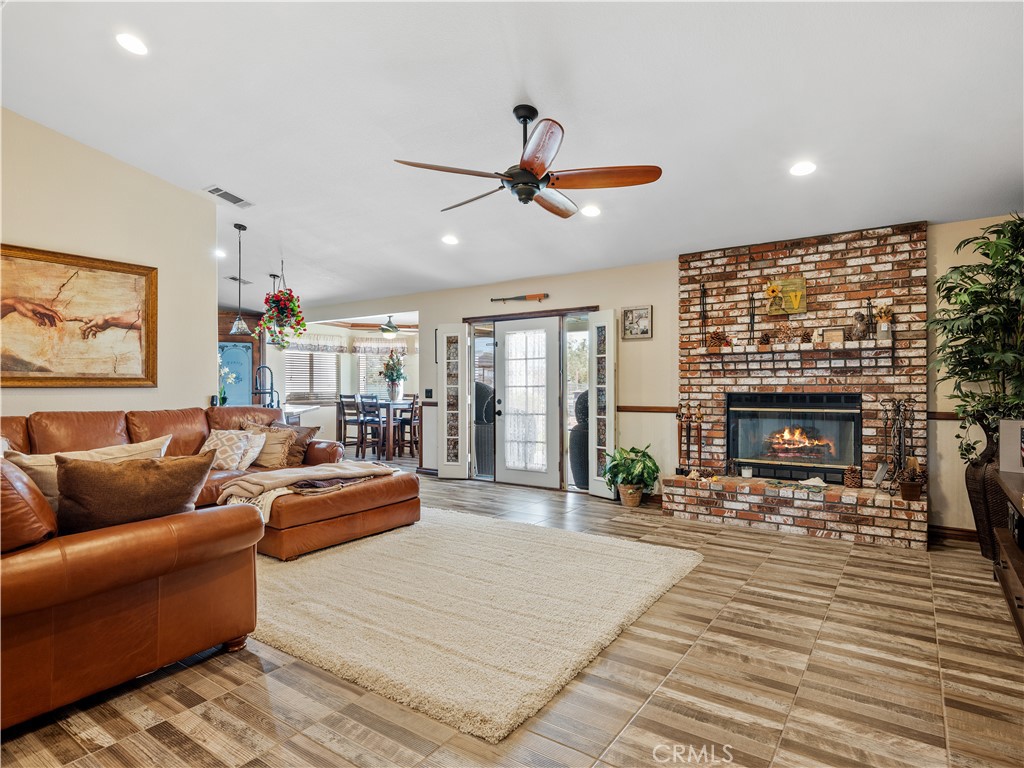 13991 Jicarilla Road Apple Valley, CA 92307 - Photo 18 of 44 a living room with furniture a fireplace and a flat screen tv