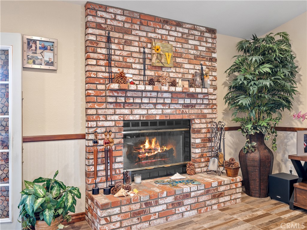 13991 Jicarilla Road Apple Valley, CA 92307 - Photo 20 of 44 a living room with furniture a fireplace and a potted plant