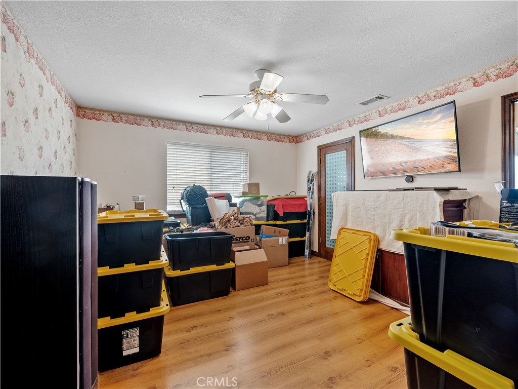 13991 Jicarilla Road Apple Valley, CA 92307 - Photo 23 of 44 a living room with furniture and a flat screen tv