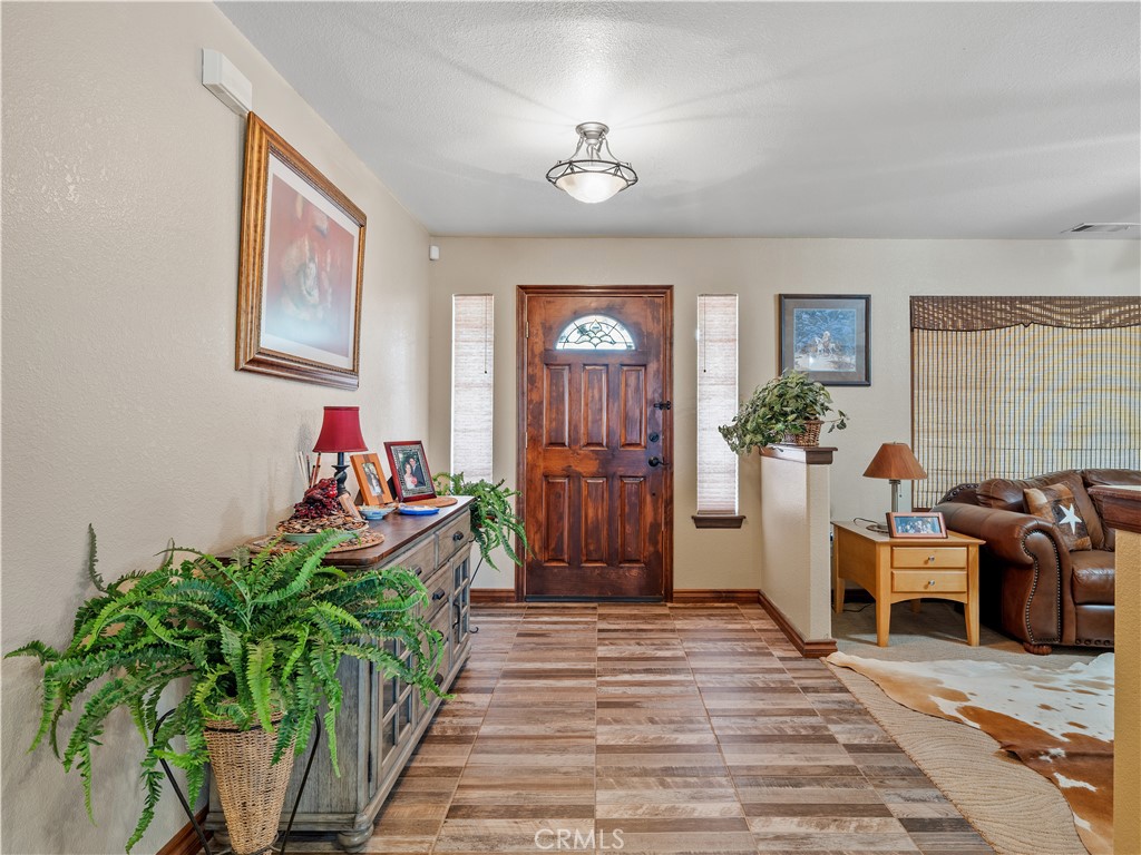 13991 Jicarilla Road Apple Valley, CA 92307 - Photo 9 of 44 a living room with furniture and a potted plant