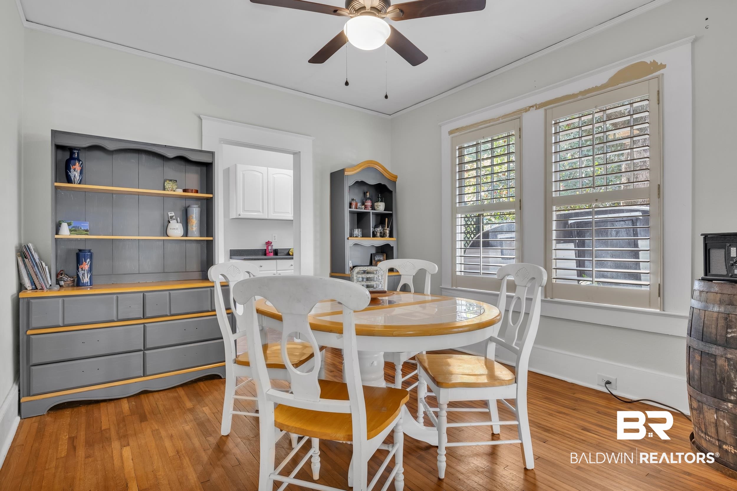 55 Mohawk Street Mobile, AL 36606 - Photo 21 of 28 Dining area featuring a ceiling fan, baseboards, light wood finished floors, and ornamental molding
