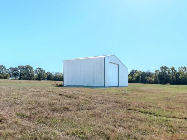 a view of a field with an trees in the background