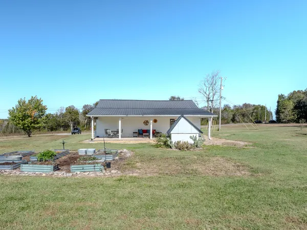 a view of a house with yard and sitting area