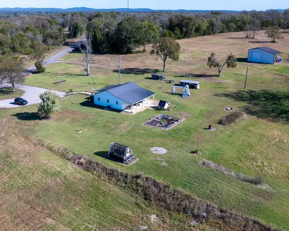 an aerial view of a house with outdoor space