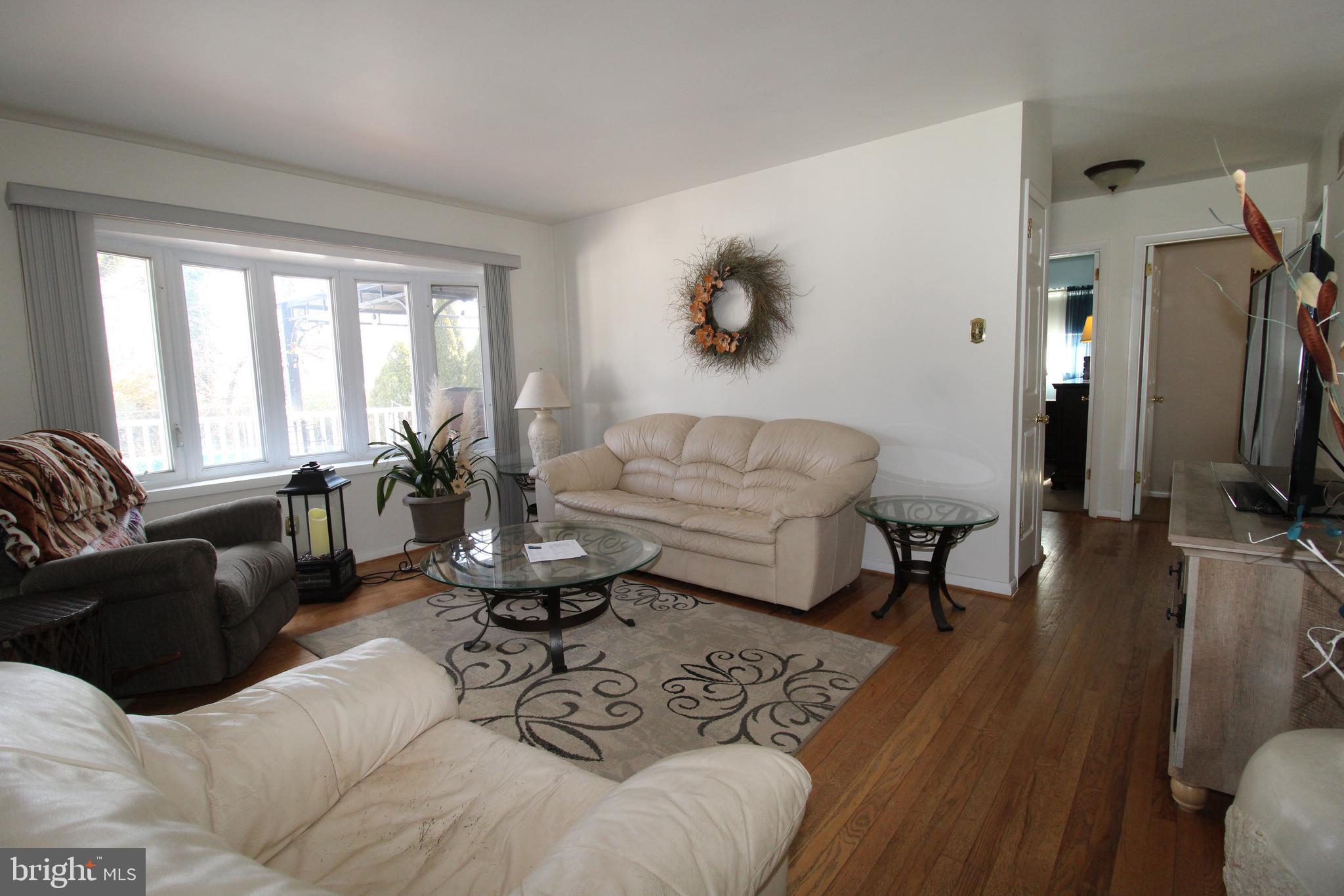 31 Northfield Road Newark, DE 19713 - Photo 12 of 54 a living room with furniture a rug potted plant and a large window