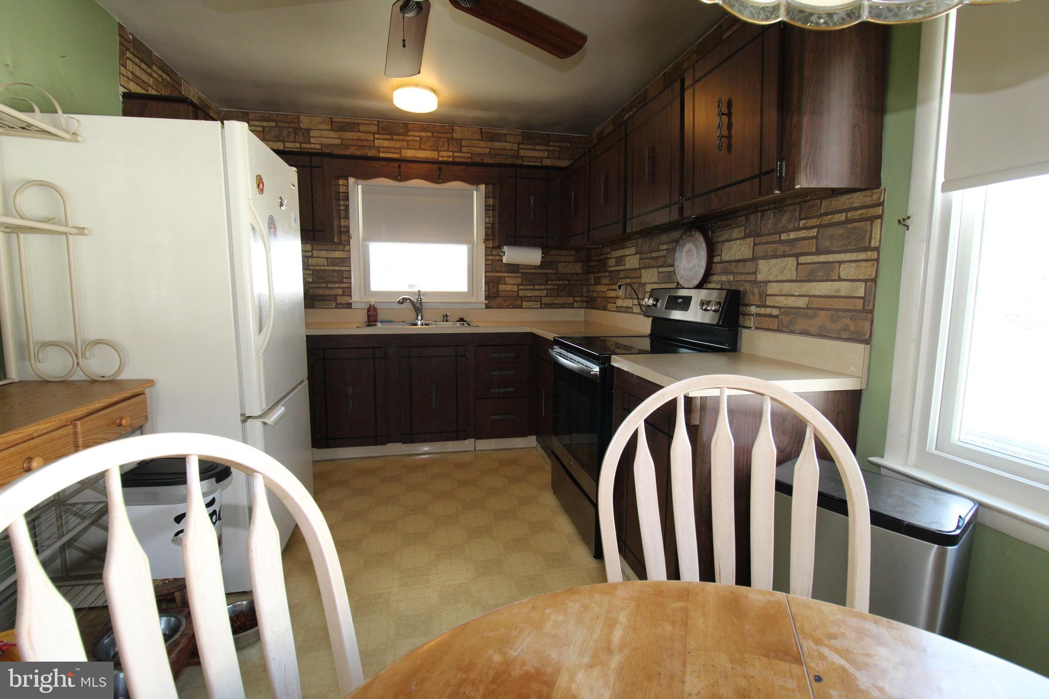 31 Northfield Road Newark, DE 19713 - Photo 14 of 54 a kitchen with stainless steel appliances granite countertop a sink refrigerator stove and microwave