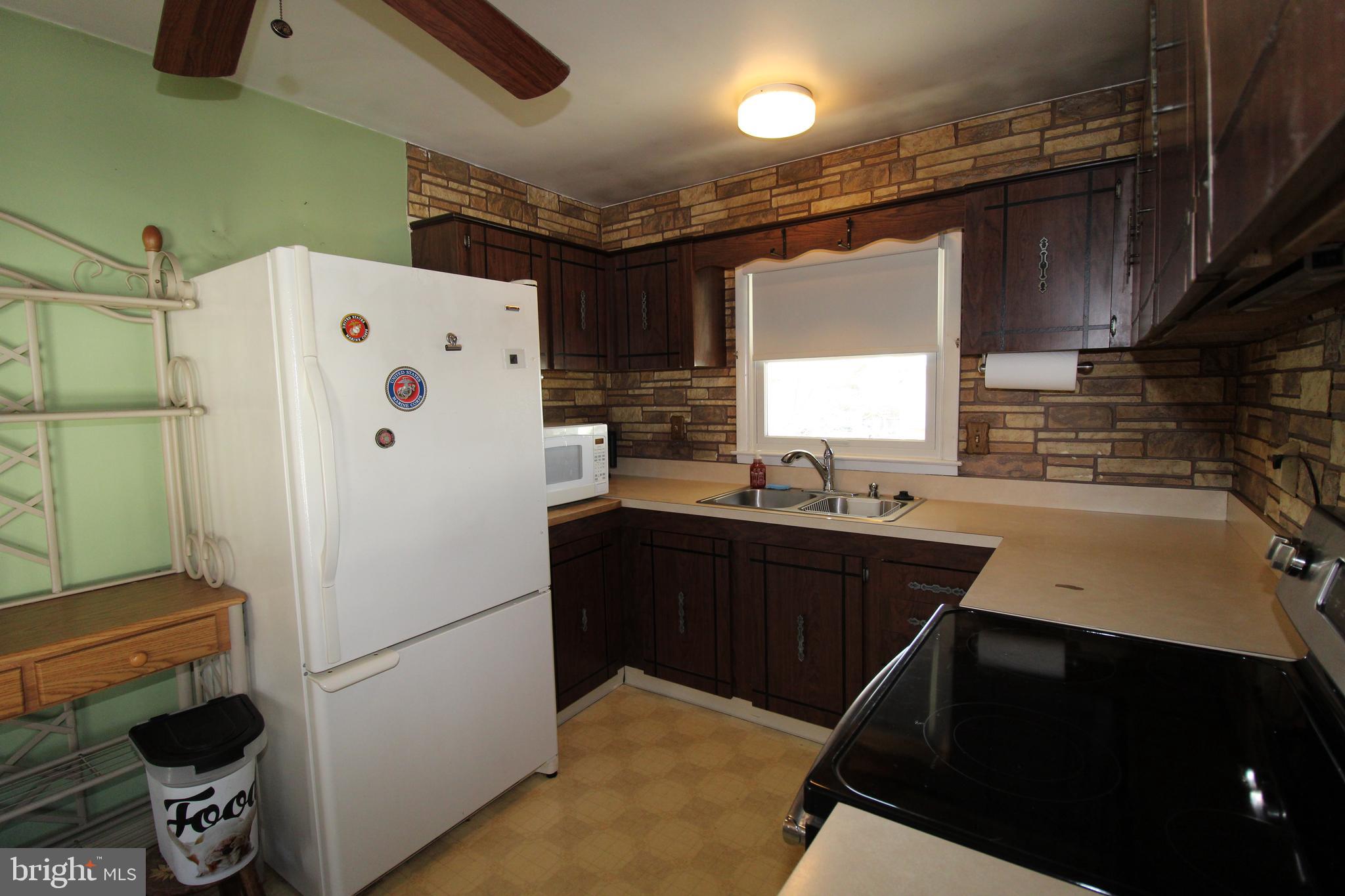 31 Northfield Road Newark, DE 19713 - Photo 18 of 54 a white refrigerator freezer sitting inside of a kitchen