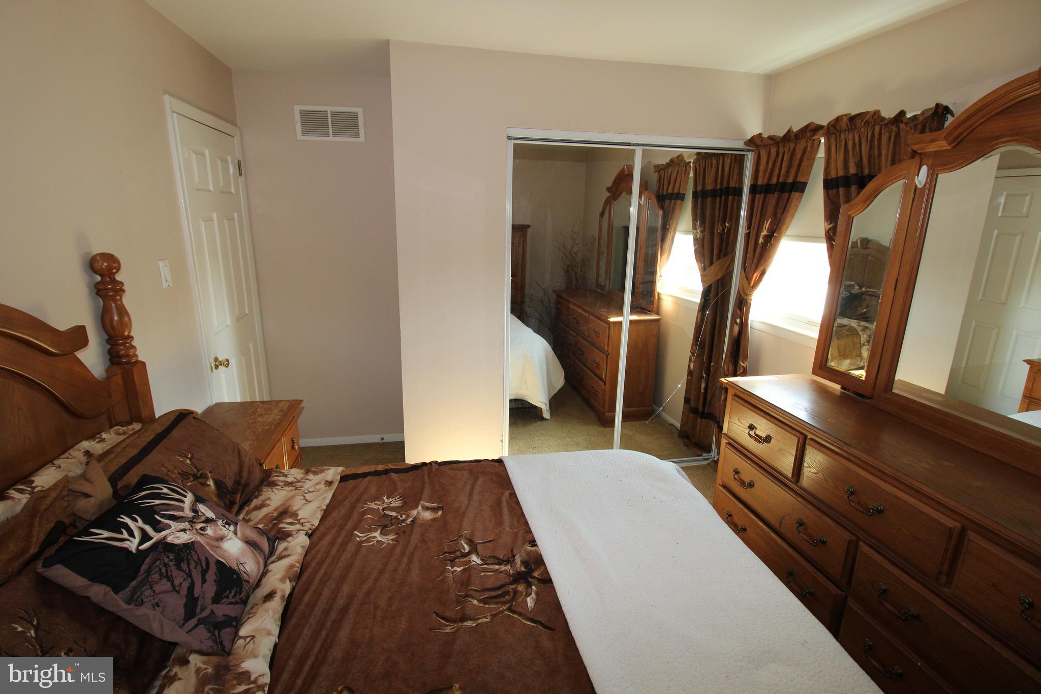 31 Northfield Road Newark, DE 19713 - Photo 22 of 54 a bedroom with a bed and wooden floor