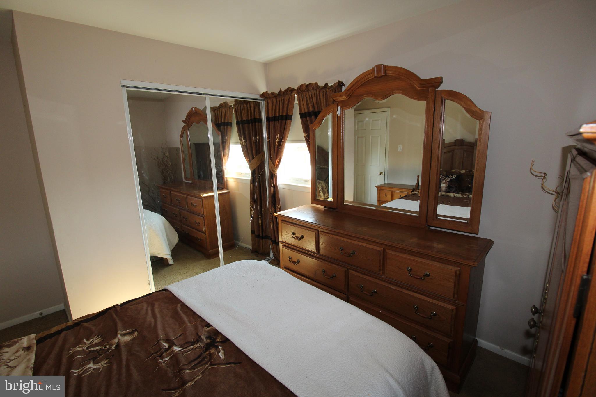31 Northfield Road Newark, DE 19713 - Photo 23 of 54 a bedroom with a bed and a mirror on dresser