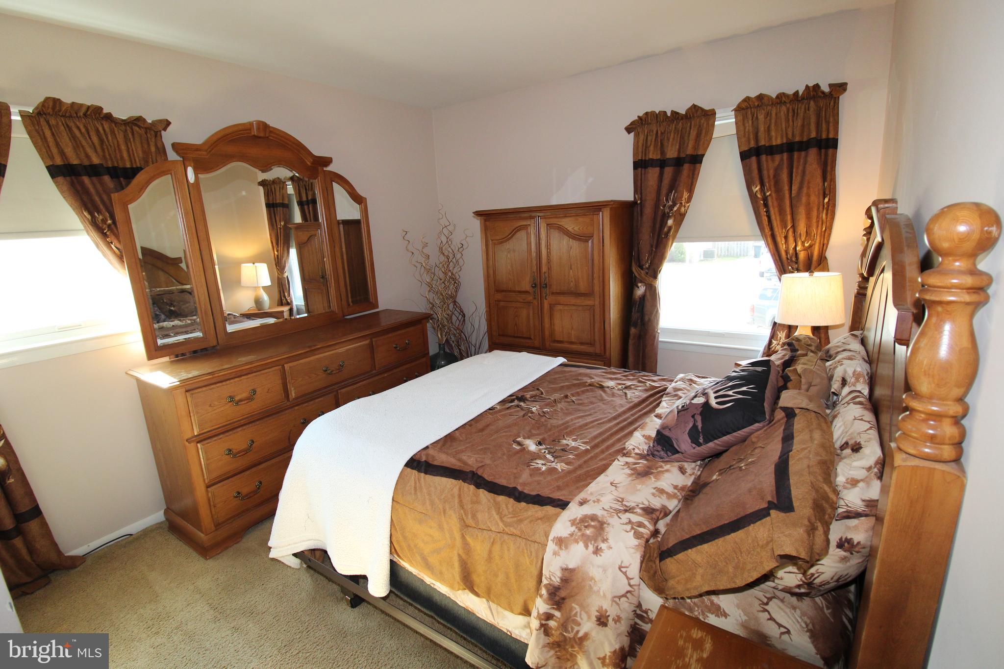 31 Northfield Road Newark, DE 19713 - Photo 26 of 54 a bedroom with a bed a mirror and dresser
