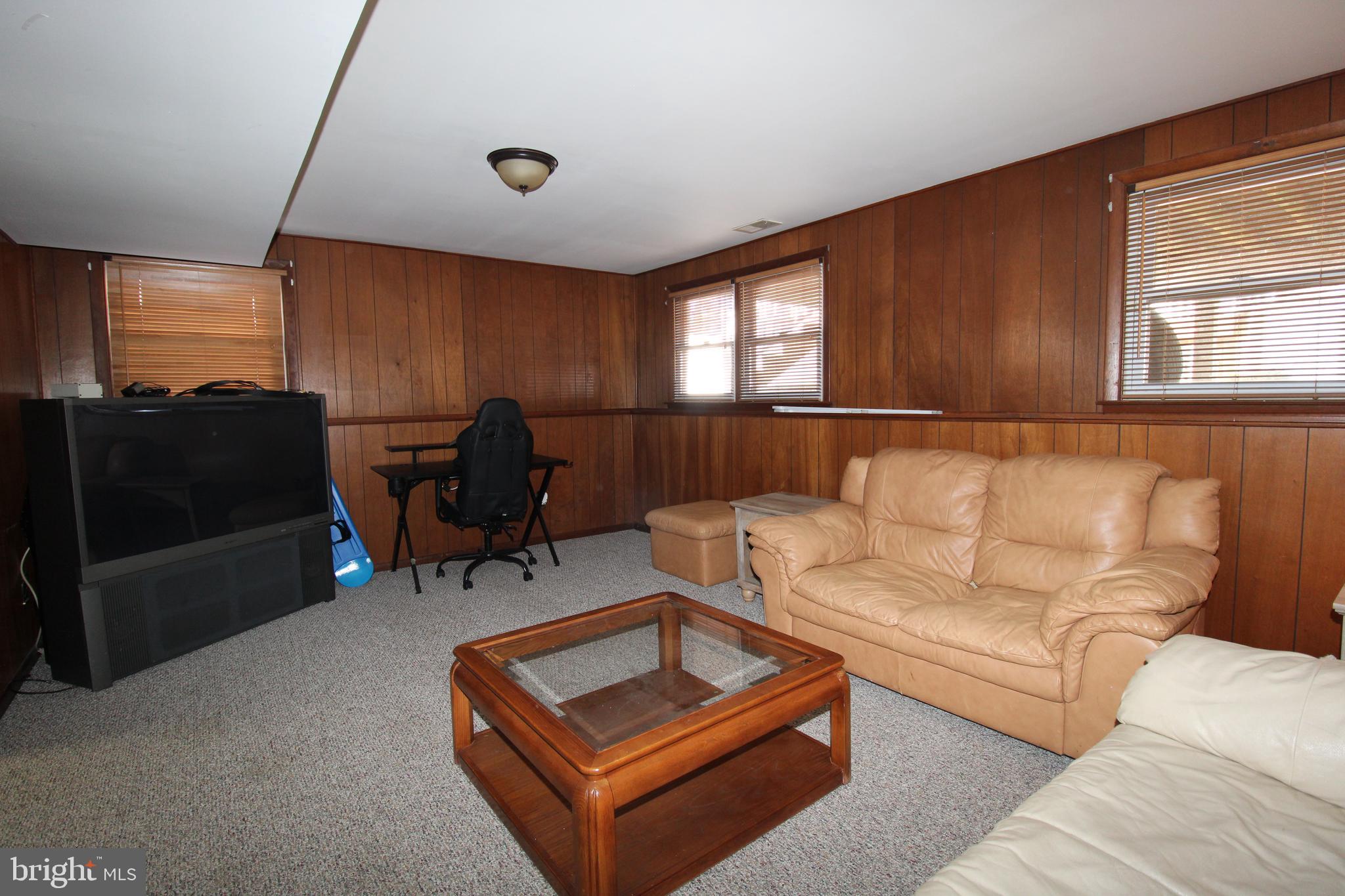 31 Northfield Road Newark, DE 19713 - Photo 35 of 54 a living room with furniture a window and a flat screen tv