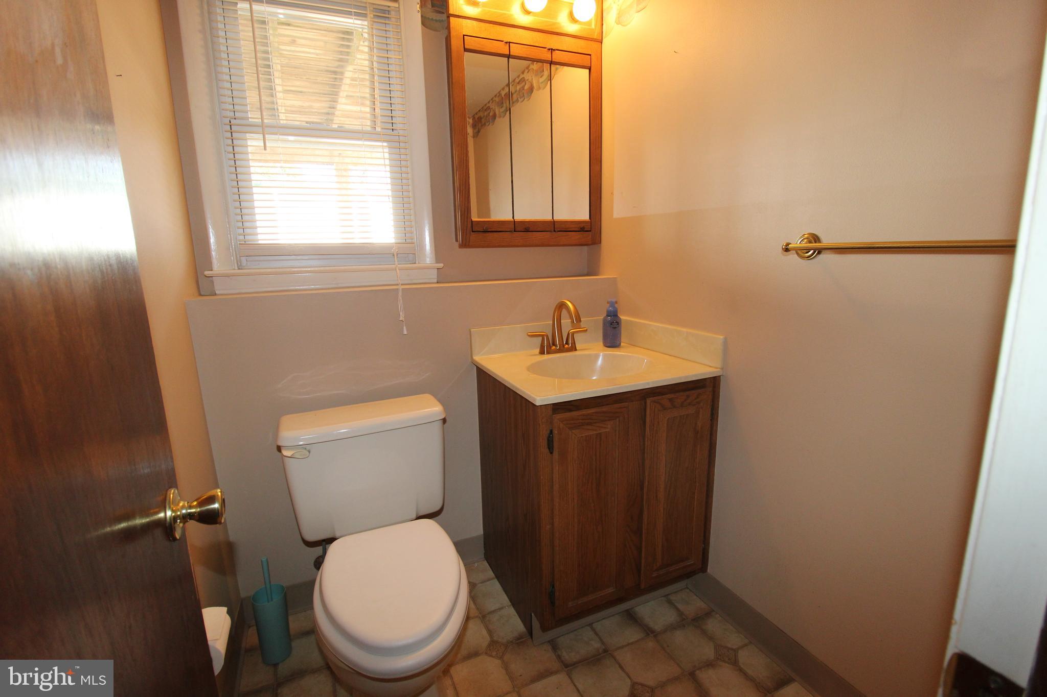 31 Northfield Road Newark, DE 19713 - Photo 45 of 54 a bathroom with a toilet a sink and a window